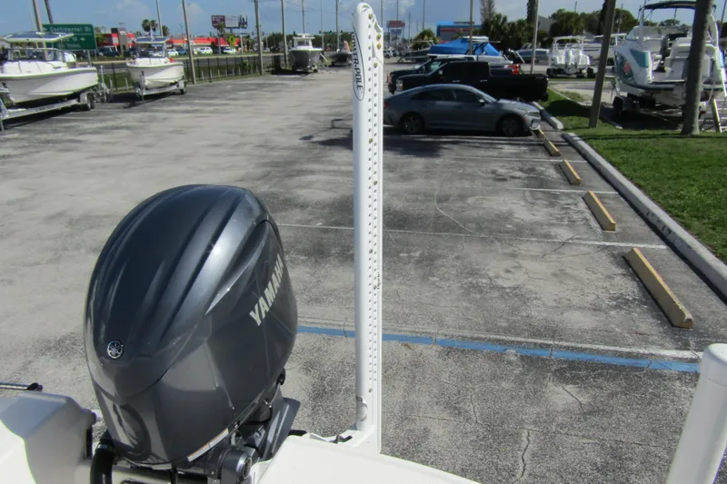 Slide: The Image of 2018 Robalo R202 Explorer with Yamaha engine in a boat dealership parking lot. - 37