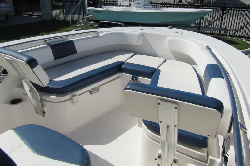 Slide: The Image of 2018 Robalo R202 Explorer boat interior with blue and white seating arrangement. - 16
