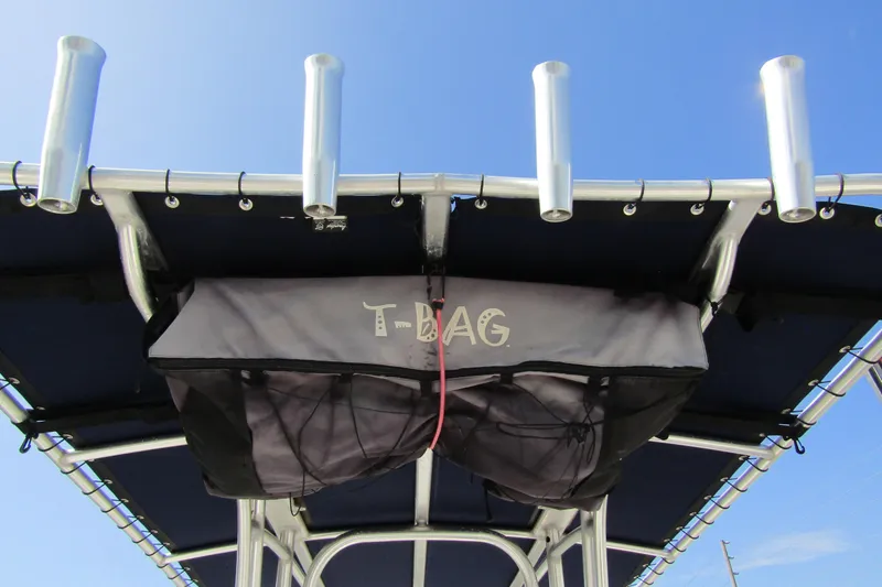 Slide: The Image of T-top storage bag on 2018 Robalo R202 Explorer boat against blue sky. - 38