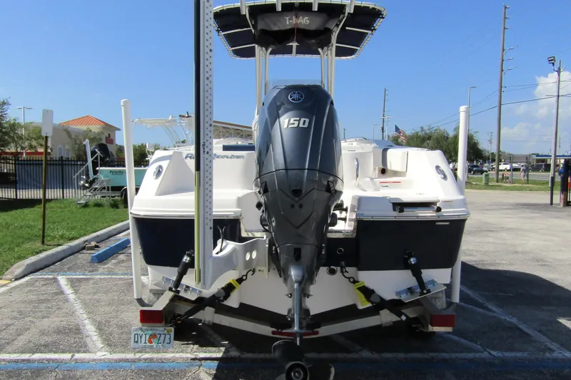 Slide: The Image of 2018 Robalo R202 Explorer boat with Yamaha 150 engine, parked outdoors. - 5