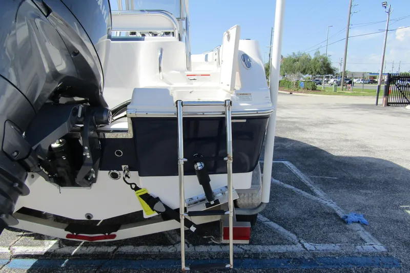 Slide: The Image of 2018 Robalo R202 Explorer boat rear view with outboard motor and ladder. - 6