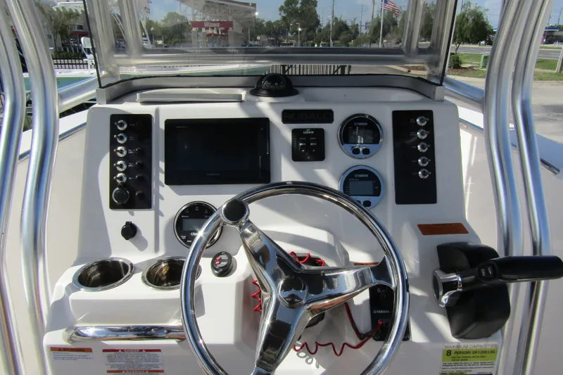 Slide: The Image of 2018 Robalo R202 Explorer boat dashboard with steering wheel and control panel. - 26