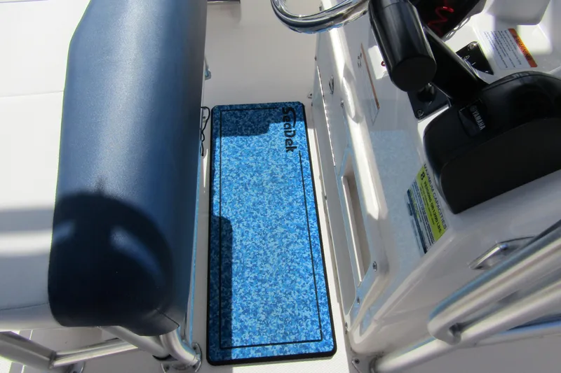 Slide: The Image of 2018 Robalo R202 Explorer boat interior with blue SeaDek flooring and control panel. - 28