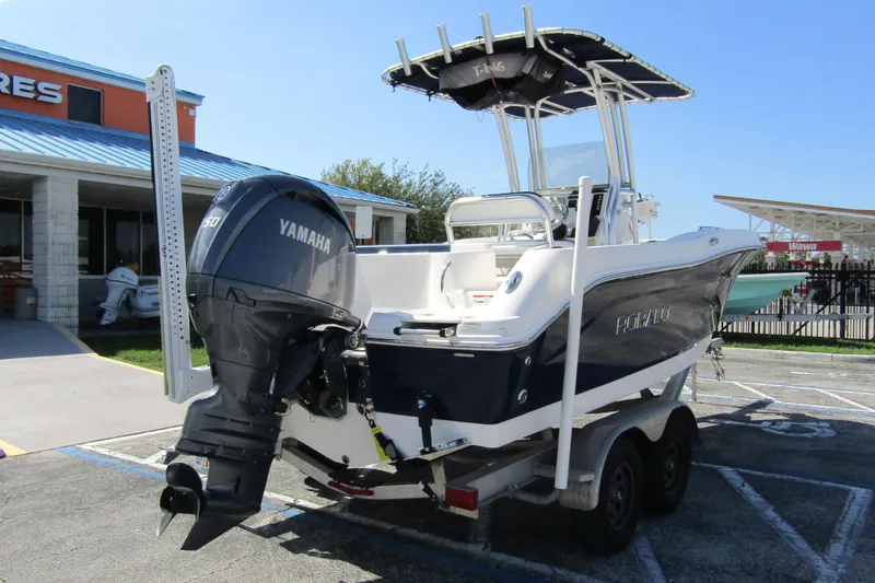 Slide: The Image of 2018 Robalo R202 Explorer boat with Yamaha engine on trailer, parked outdoors. - 4