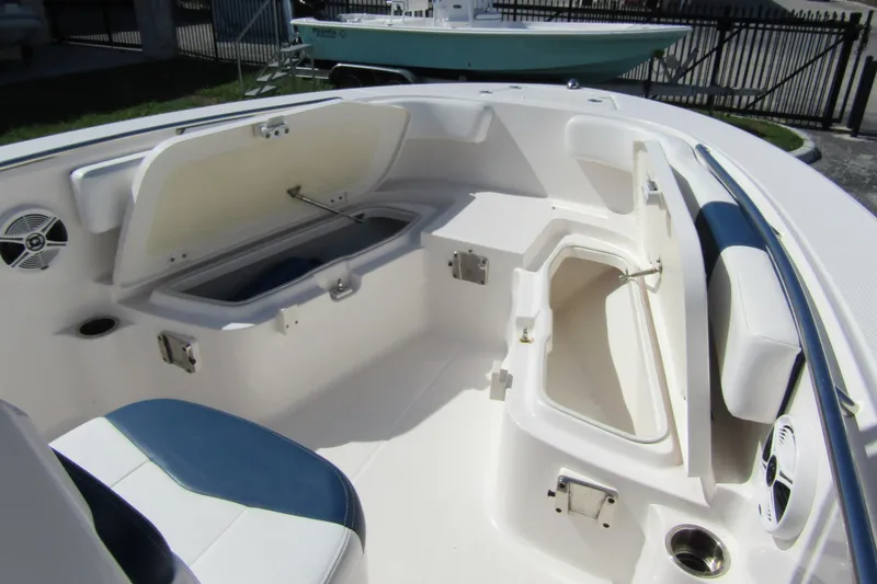 Slide: The Image of 2018 Robalo R202 Explorer boat interior with open storage compartments and seating. - 13