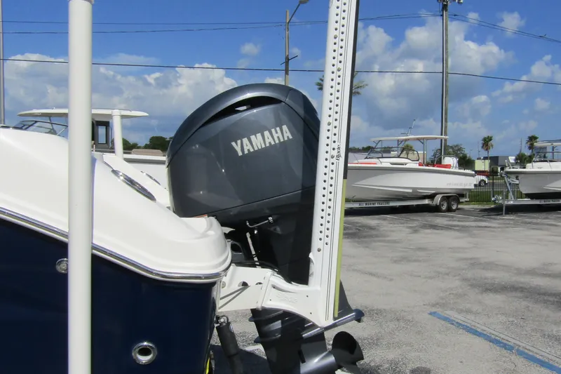 Slide: The Image of 2018 Robalo R202 Explorer with Yamaha outboard motor in a boatyard setting. - 8