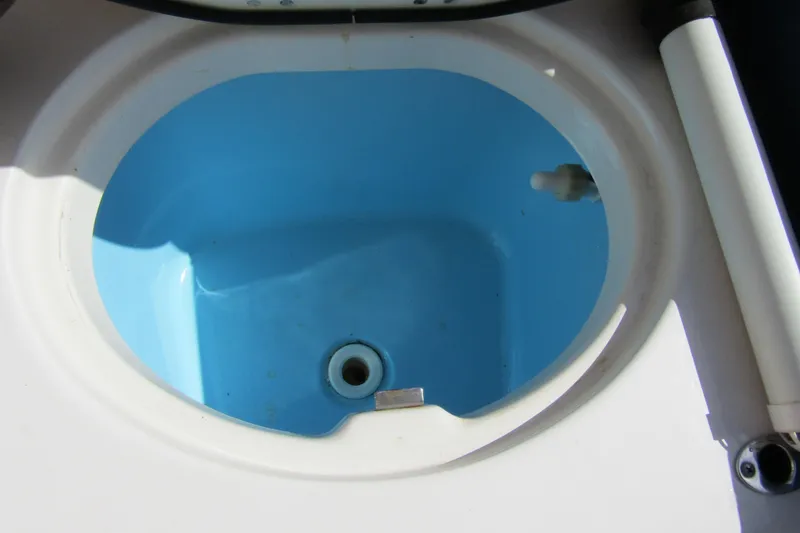 Slide: The Image of Livewell compartment of 2018 Robalo R202 Explorer boat, featuring a blue interior. - 33