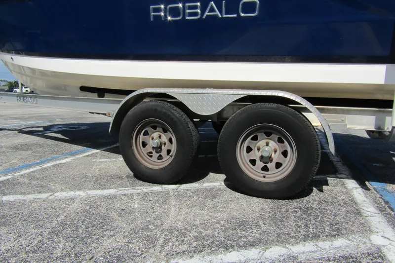 Slide: The Image of 2018 Robalo R202 Explorer boat on trailer, close-up of wheels and hull. - 9