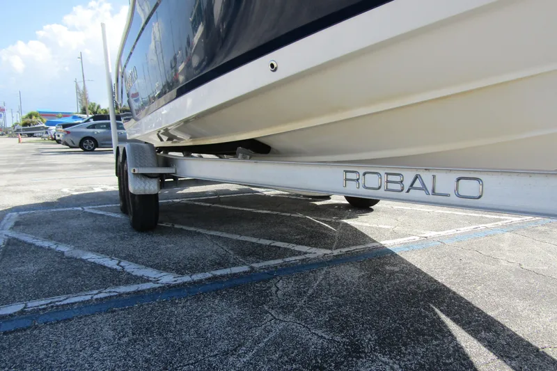 Slide: The Image of 2018 Robalo R202 Explorer boat on trailer in parking lot. - 11