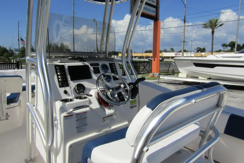 Slide: The Image of 2018 Robalo R202 Explorer boat cockpit with steering wheel and control panel. - 25