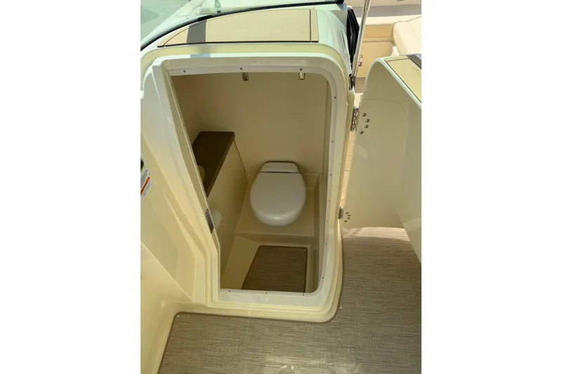 Slide: The Image of 2027 Chris-Craft Calypso 28 boat interior with compact marine toilet. - 21