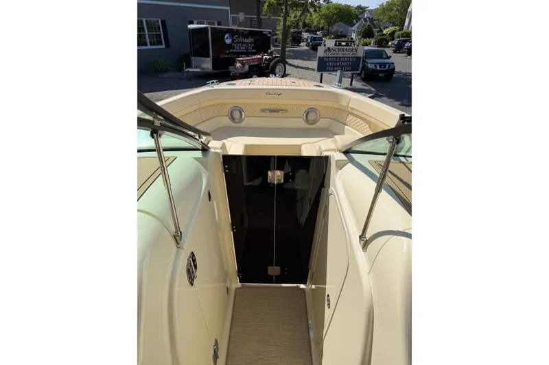 Slide: The Image of 2027 Chris-Craft Calypso 28 boat interior with open cabin door, showcasing luxury design. - 19