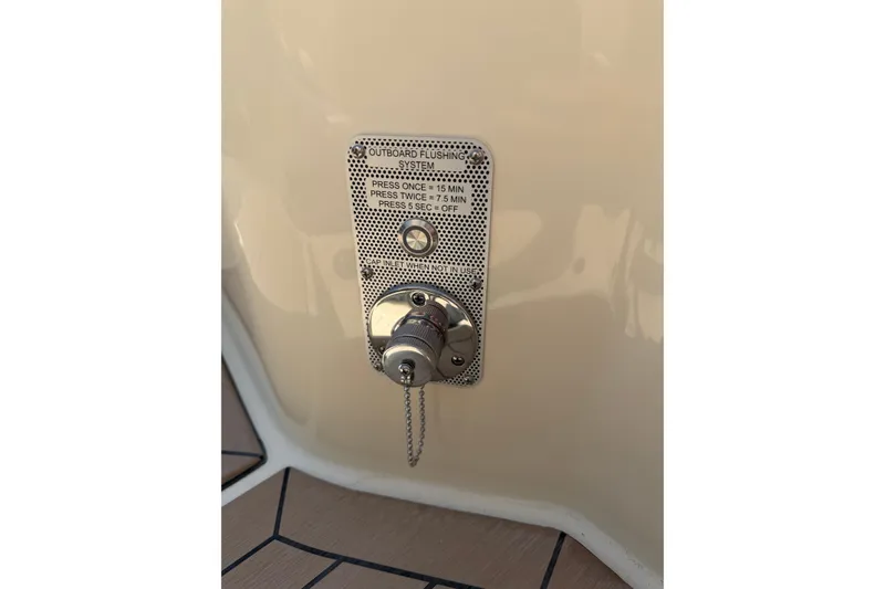 Slide: The Image of Outboard flushing system on 2027 Chris-Craft Calypso 28 boat, featuring control instructions. - 15