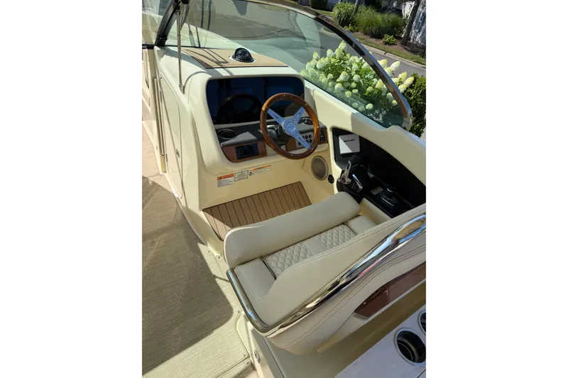 Slide: The Image of 2027 Chris-Craft Calypso 28 boat interior with steering wheel and dashboard. - 22
