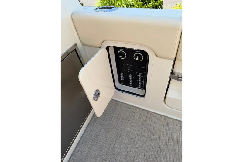 Slide: The Image of Control panel of 2027 Chris-Craft Calypso 28 boat with open access door. - 31