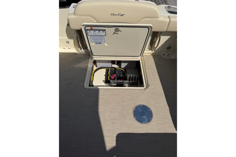 Slide: The Image of 2027 Chris-Craft Calypso 28 boat interior showing open storage compartment with wiring. - 34