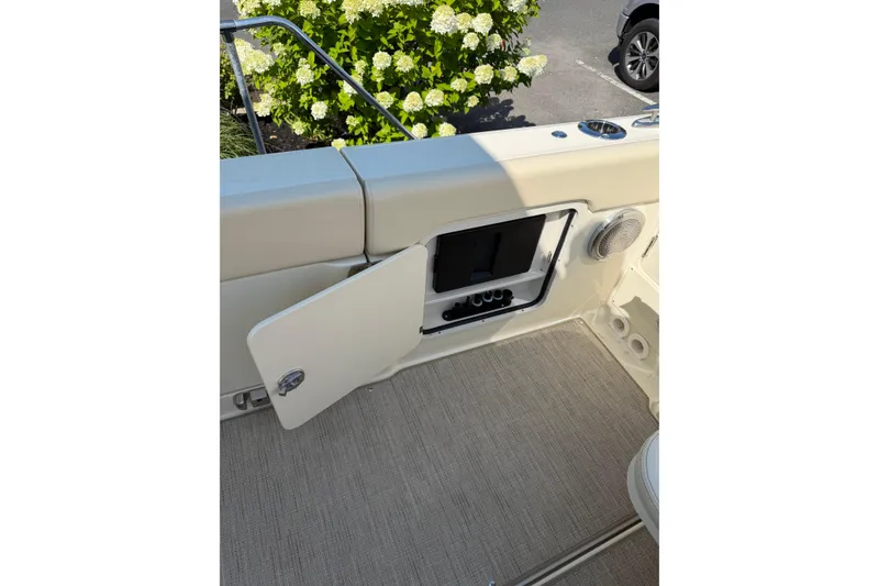 Slide: The Image of 2027 Chris-Craft Calypso 28 boat interior with open storage compartment and speaker. - 32