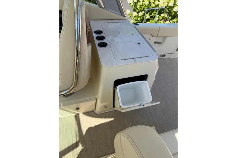 Slide: The Image of Interior view of 2027 Chris-Craft Calypso 28 boat with storage compartment and cup holders. - 30