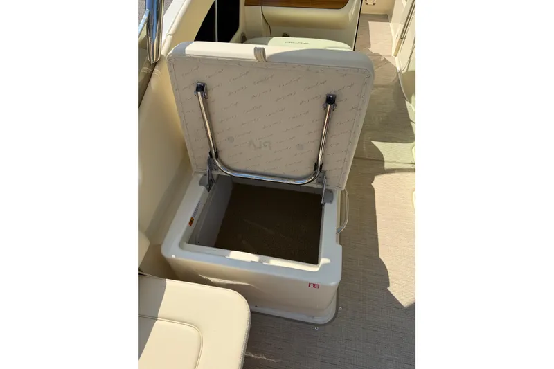 Slide: The Image of Open storage compartment on 2027 Chris-Craft Calypso 28 boat, featuring cushioned seating. - 27
