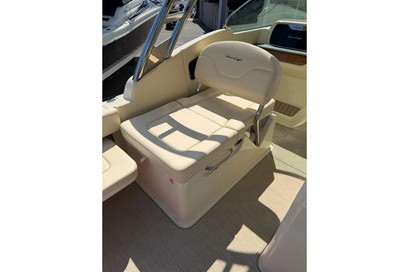 Slide: The Image of 2027 Chris-Craft Calypso 28 boat seat with beige upholstery and chrome accents. - 26