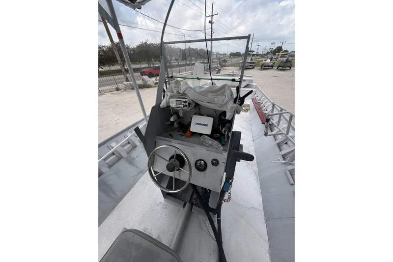 Slide: The Image of 2012 Southfork 27 boat dashboard with steering wheel and navigation equipment. - 12