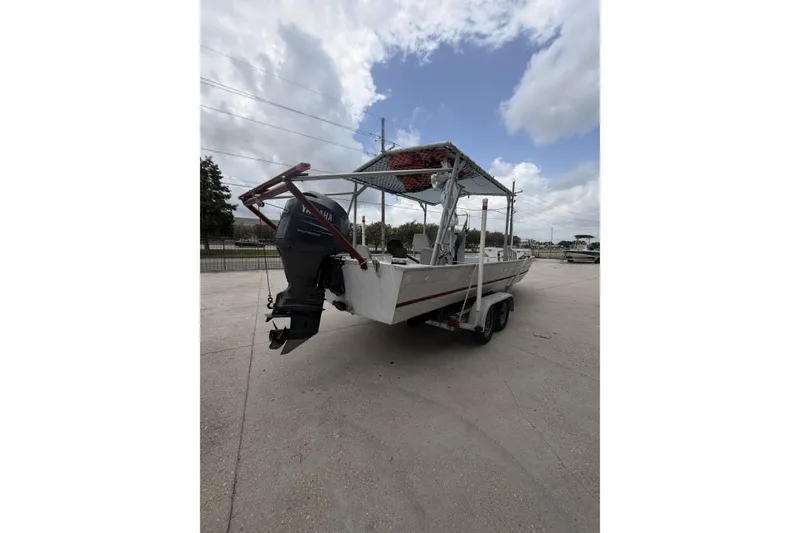 Slide: The Image of 2012 Southfork 27 boat with Yamaha outboard motor on trailer under cloudy sky. - 6