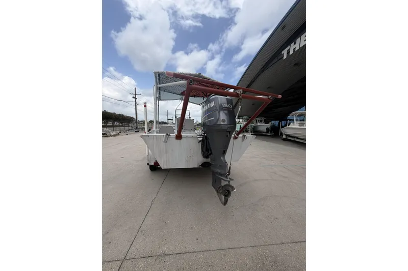 Slide: The Image of 2012 Southfork 27 boat with Yamaha 150 outboard motor, parked outdoors. - 7
