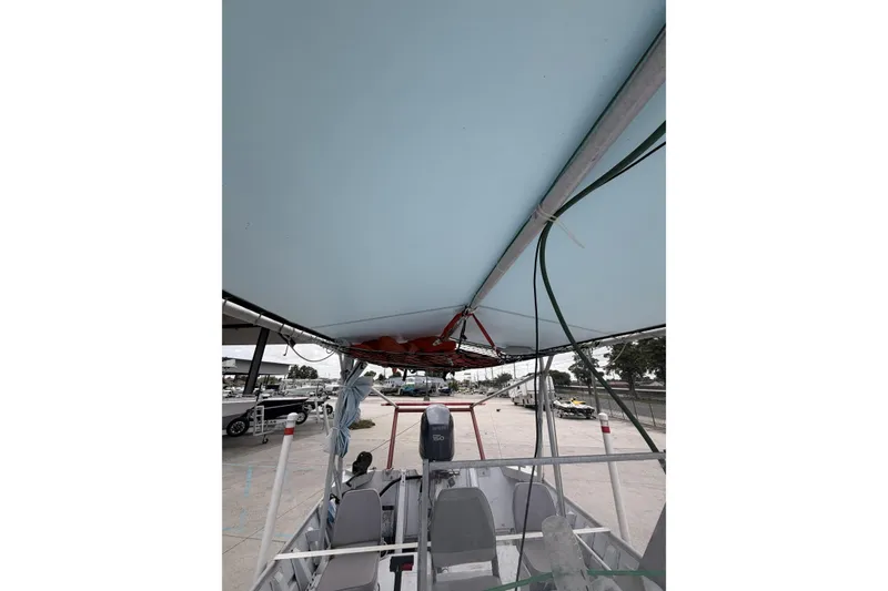 Slide: The Image of 2012 Southfork 27 boat interior view with canopy and seating arrangement. - 14