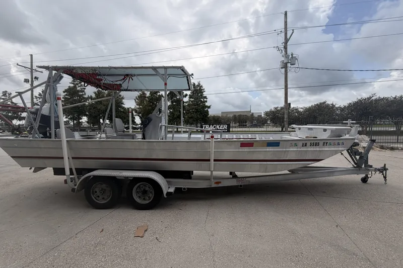 Slide: The Image of 2012 Southfork 27 boat on trailer, parked outdoors under cloudy sky. - 5