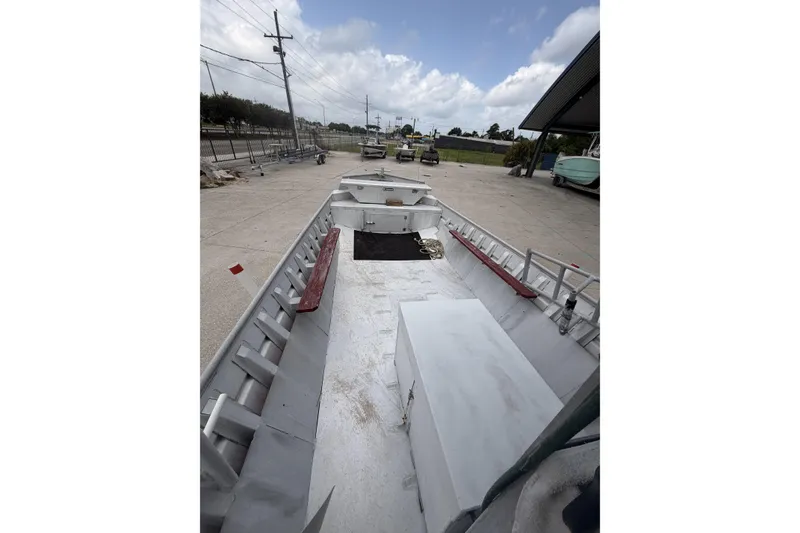 Slide: The Image of Open deck of a 2012 Southfork 27 boat, parked on a concrete lot. - 9