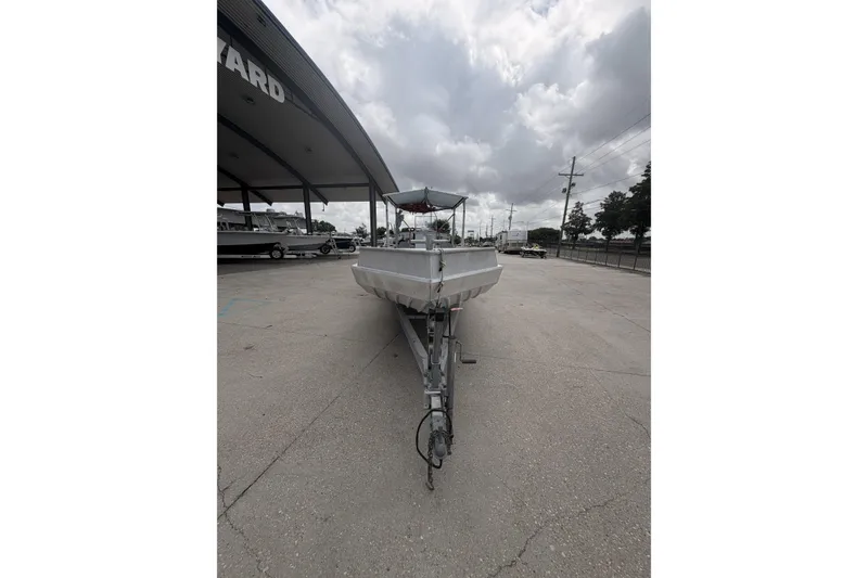 Slide: The Image of 2012 Southfork 27 boat on trailer under cloudy sky at a boatyard. - 3