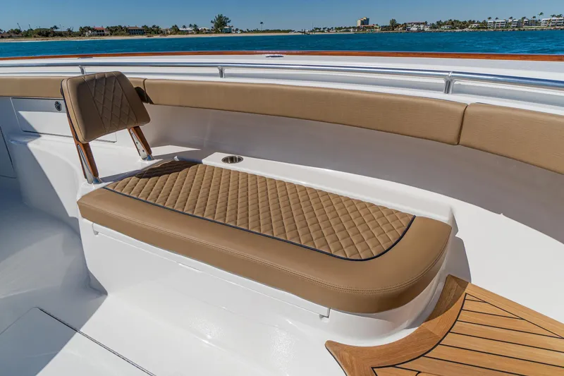Slide: The Image of 2025 Valhalla Boatworks V-46 interior with tan quilted seating and ocean view. - 30