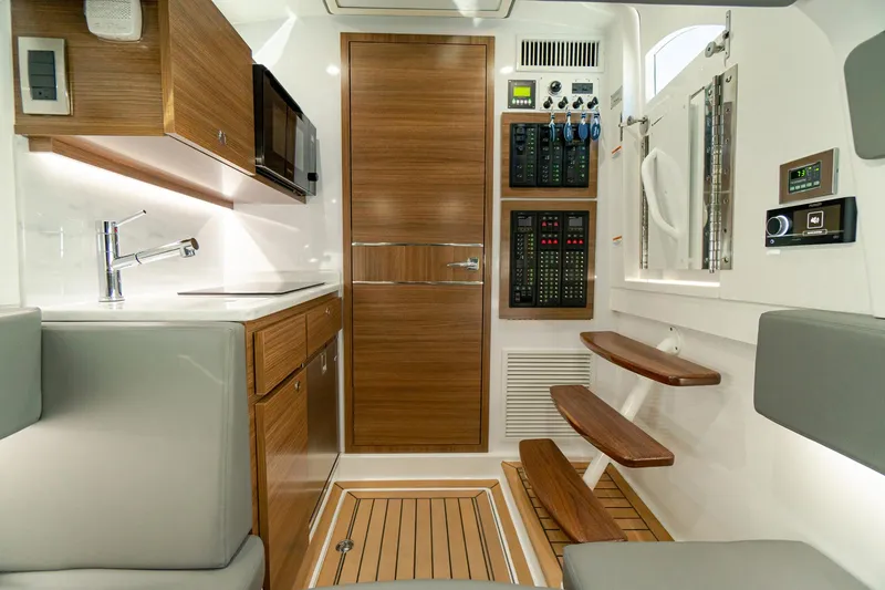Slide: The Image of 2025 Valhalla Boatworks V-46 interior with modern kitchen and control panel. - 23