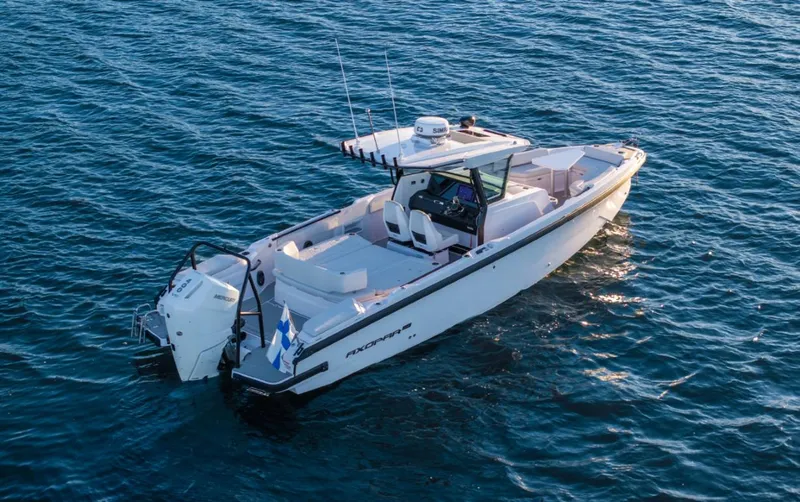 Slide: The Image of 2025 Axopar 29 CCX boat on open water, showcasing sleek design and modern features. - 13