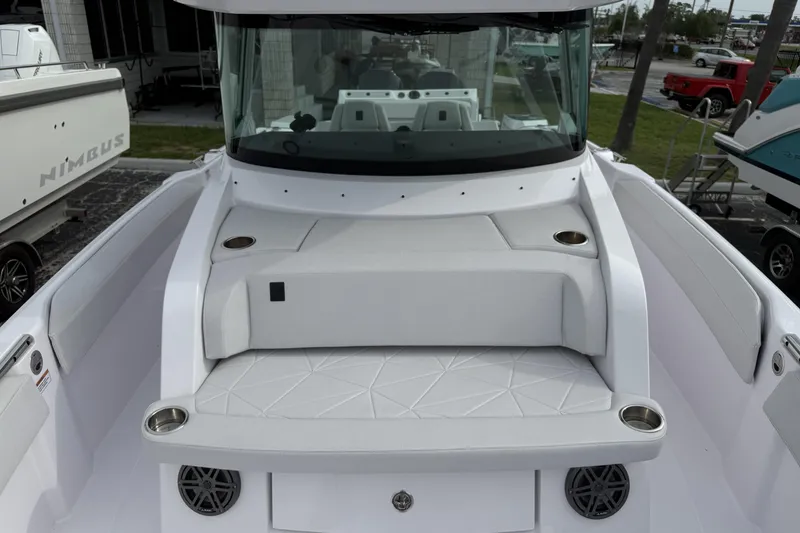 Slide: The Image of 2025 Axopar 29 CCX boat interior with white seating and cup holders. - 5