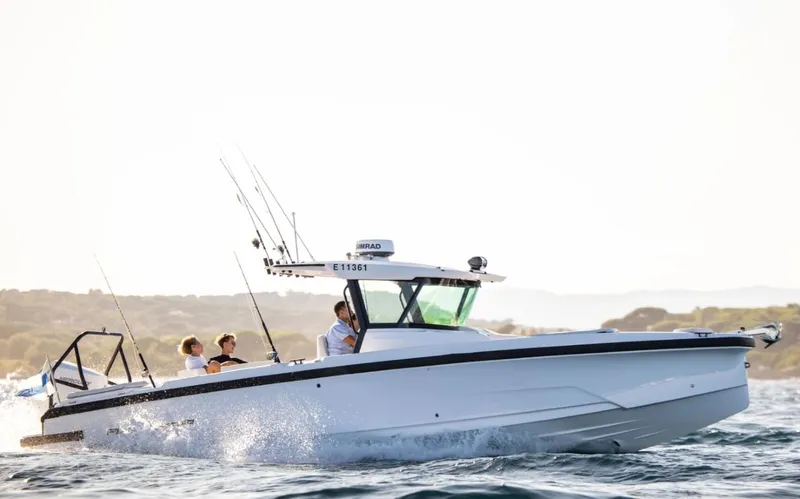 Slide: The Image of 2025 Axopar 29 CCX boat cruising on open water with passengers. - 11