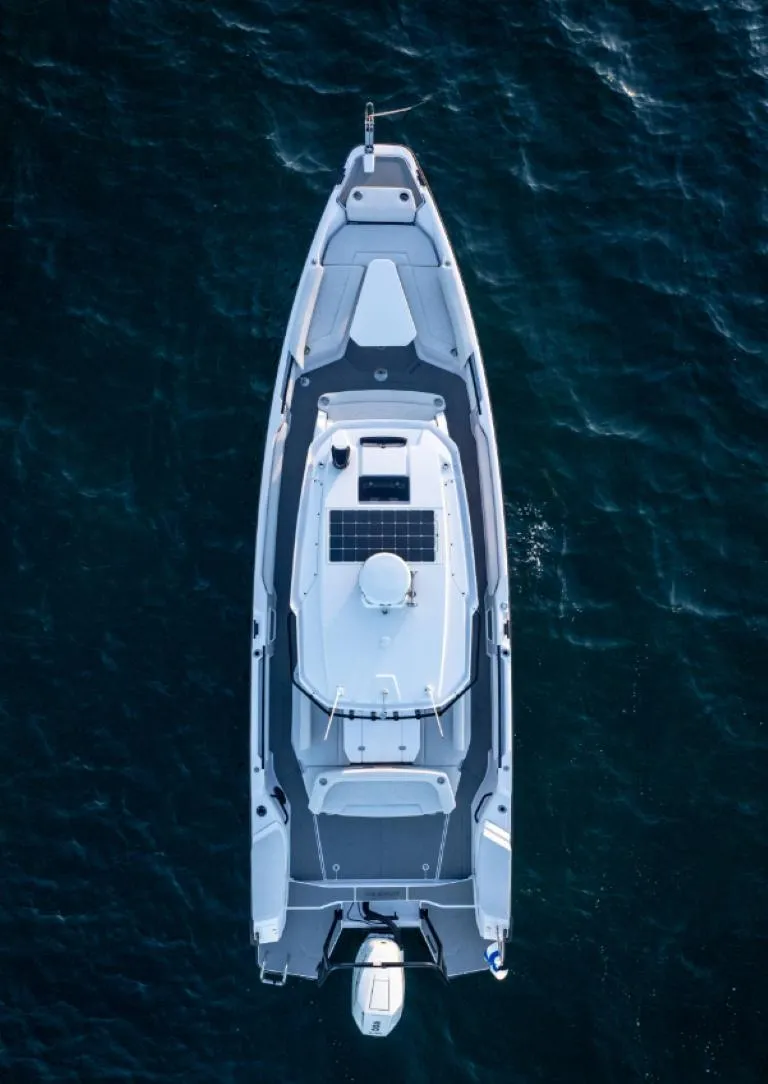 Slide: The Image of Aerial view of 2025 Axopar 29 CCX boat on dark blue water. - 14