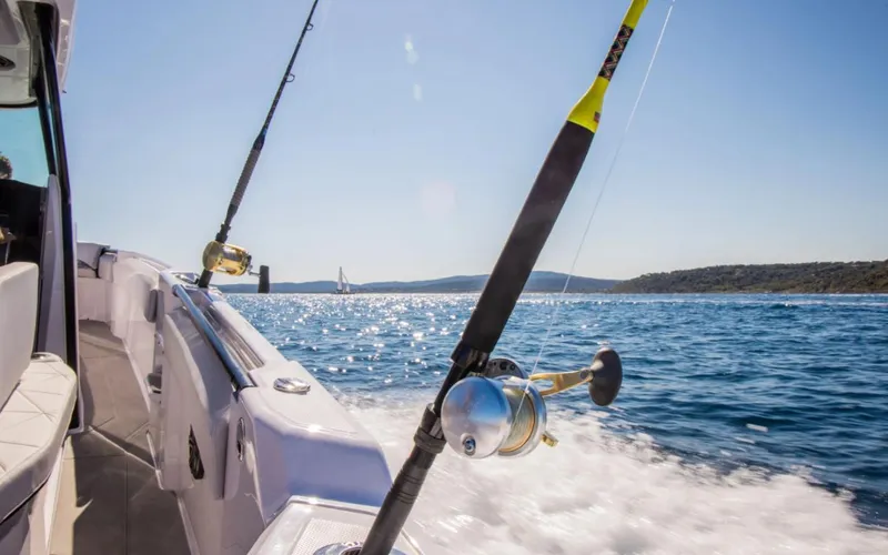 Slide: The Image of 2025 Axopar 29 CCX boat with fishing rods on a sunny day at sea. - 20
