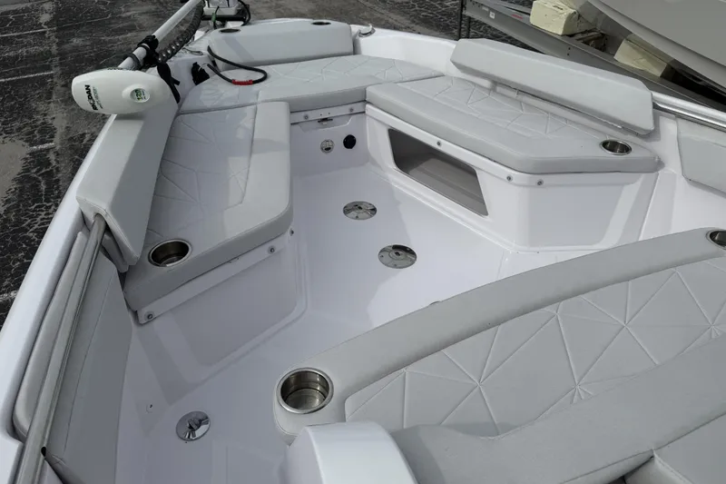 Slide: The Image of 2025 Axopar 29 CCX boat interior with cushioned seating and cup holders. - 4