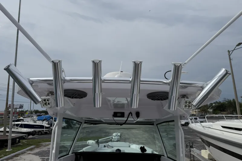 Slide: The Image of 2025 Axopar 29 CCX boat with rod holders and speakers on the roof. - 8