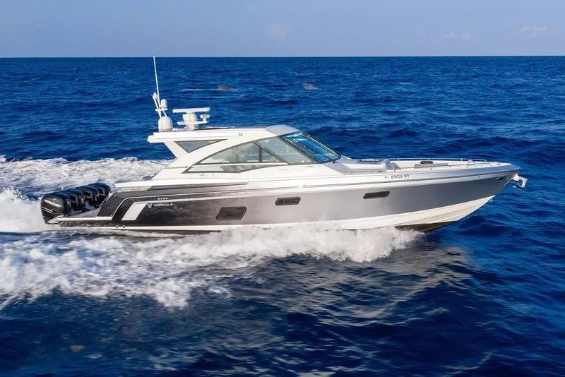 The Image of The 2018 Formula 430 Super Sport Crossover speeds across the blue sea, featuring four outboard engines. - 0
