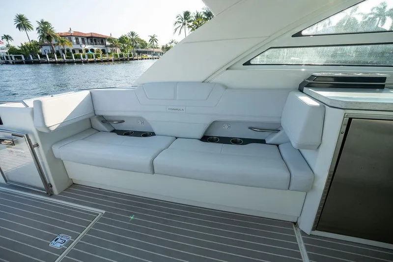 Slide: The Image of The 2018 Formula 430 Super Sport Crossover features a luxurious white seating area overlooking the water. - 33