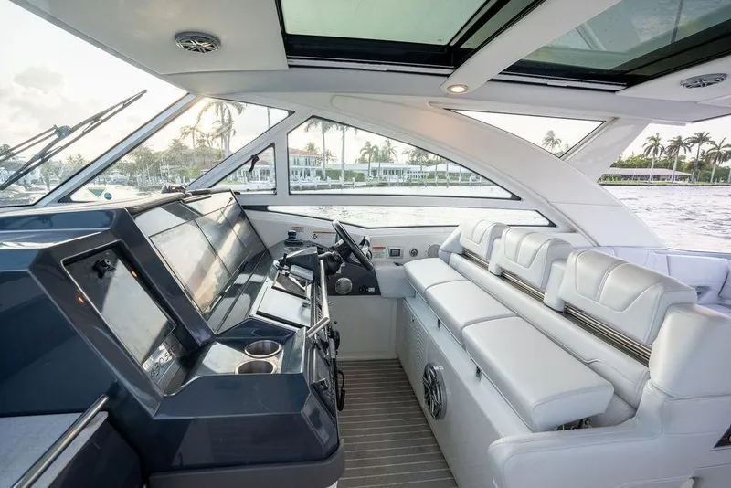 Slide: The Image of Interior view of a luxury yacht with white leather seating and a modern cockpit. - 46