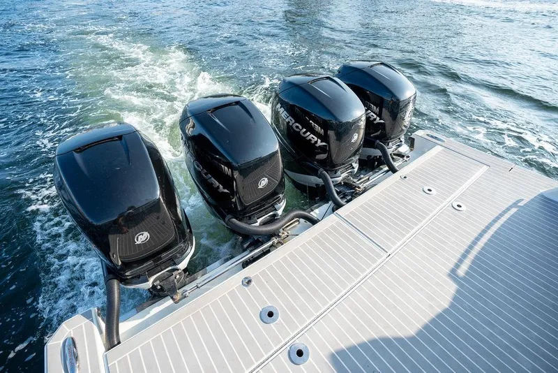 Slide: The Image of Four powerful outboard engines propel the boat across the water, leaving a foamy wake. - 28