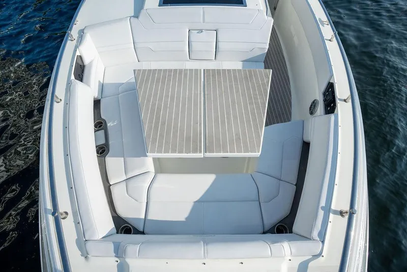 Slide: The Image of The 2018 Formula 430 Super Sport Crossover features a spacious, luxurious seating area with a sleek table. - 21