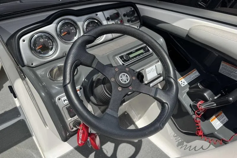 Slide: The Image of 2011 Yamaha Boats AR240 HO dashboard with steering wheel and control panel. - 5
