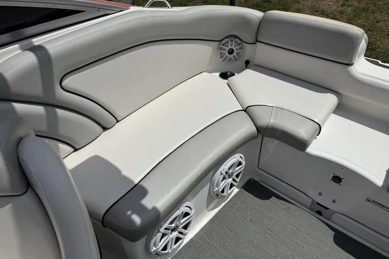 Slide: The Image of 2011 Yamaha Boats AR240 HO interior with cushioned seating and built-in speakers. - 4