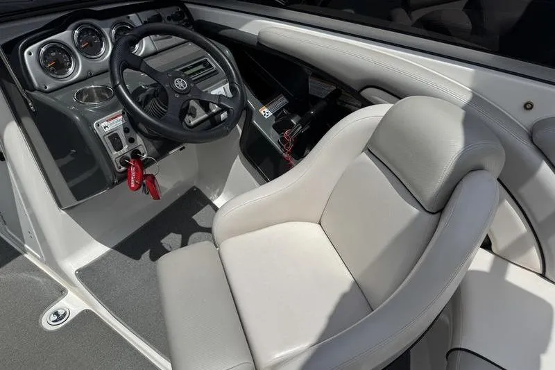 Slide: The Image of 2011 Yamaha Boats AR240 HO cockpit with steering wheel and comfortable seating. - 18