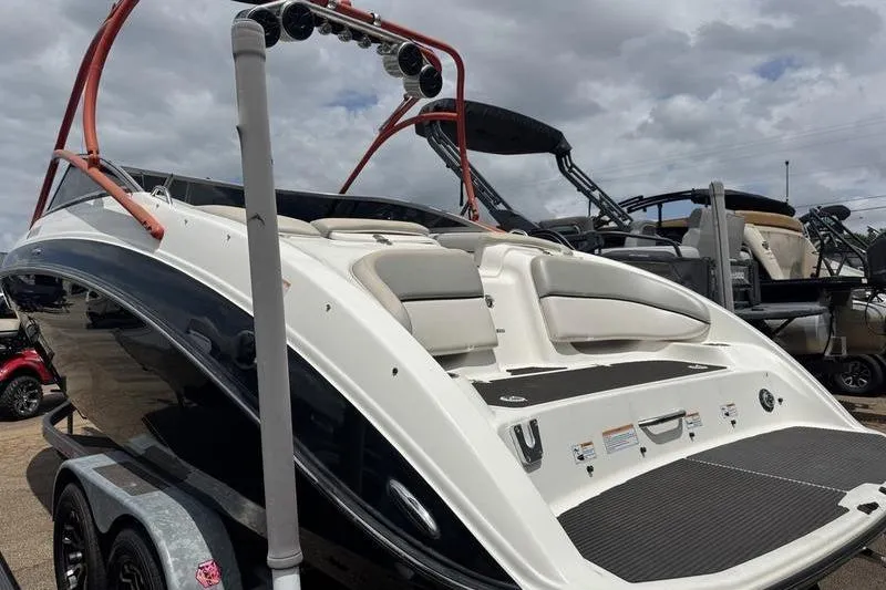 Slide: The Image of 2011 Yamaha Boats AR240 HO on trailer, showcasing sleek design and spacious seating. - 12