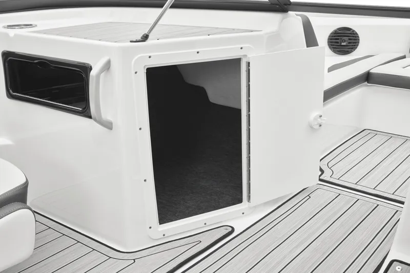 Slide: The Image of An open storage compartment on a 2024 Yamaha 195S boat, featuring wood flooring and seating area. - 38